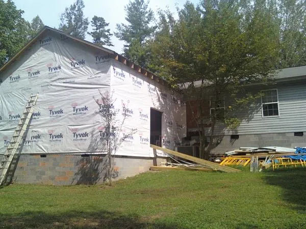 Tyvek wrapped gable on a new room addition beside an existing home in Annandale