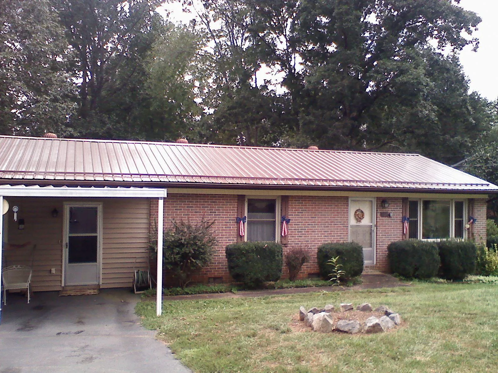 Bronze metal roof and carport on a brick ranch home — Roof Repair work by our crew in Annandale
