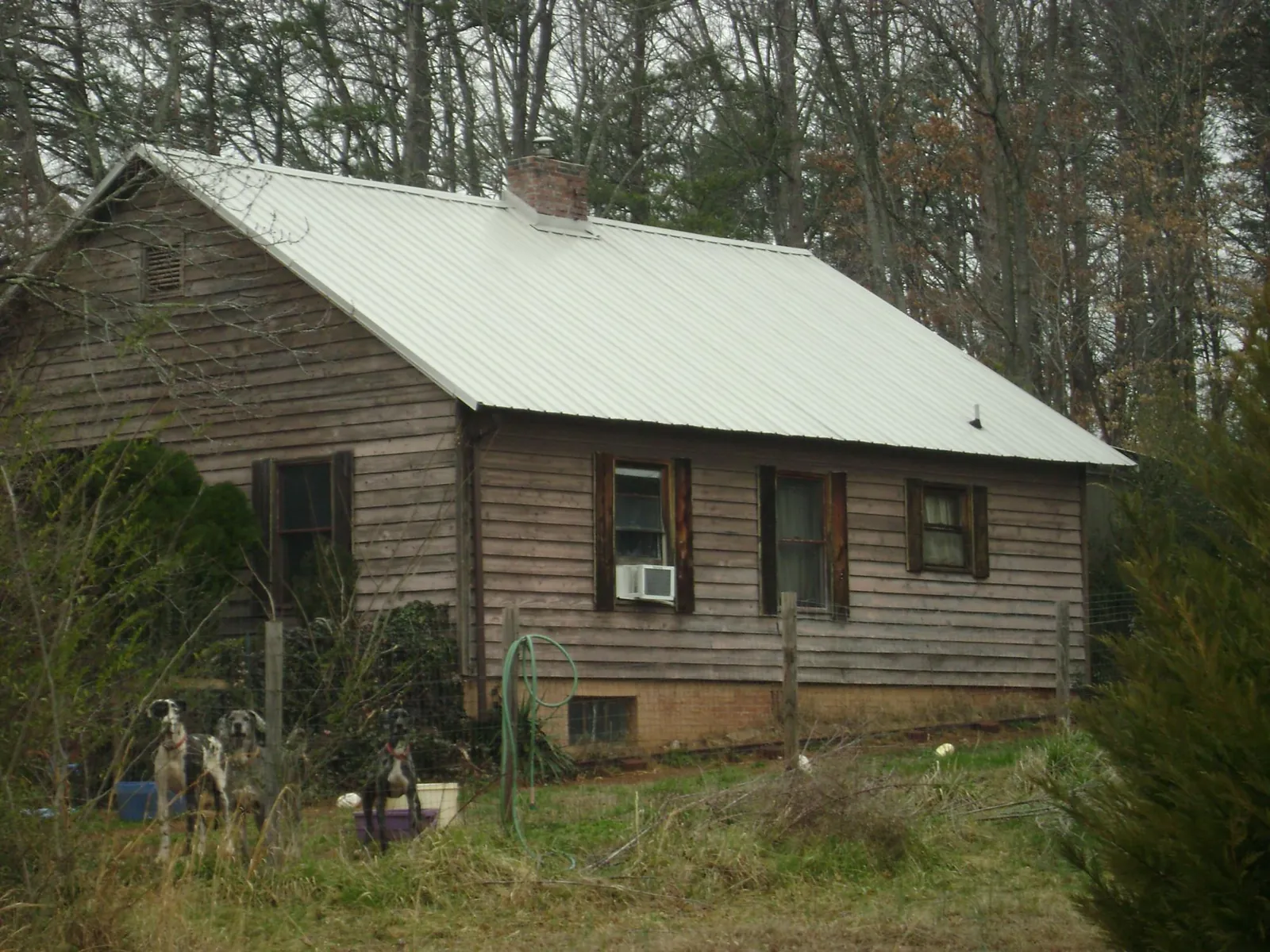 White metal roof on an old wood sided farmhouse, from a Metal Roof Installation job in Annandale